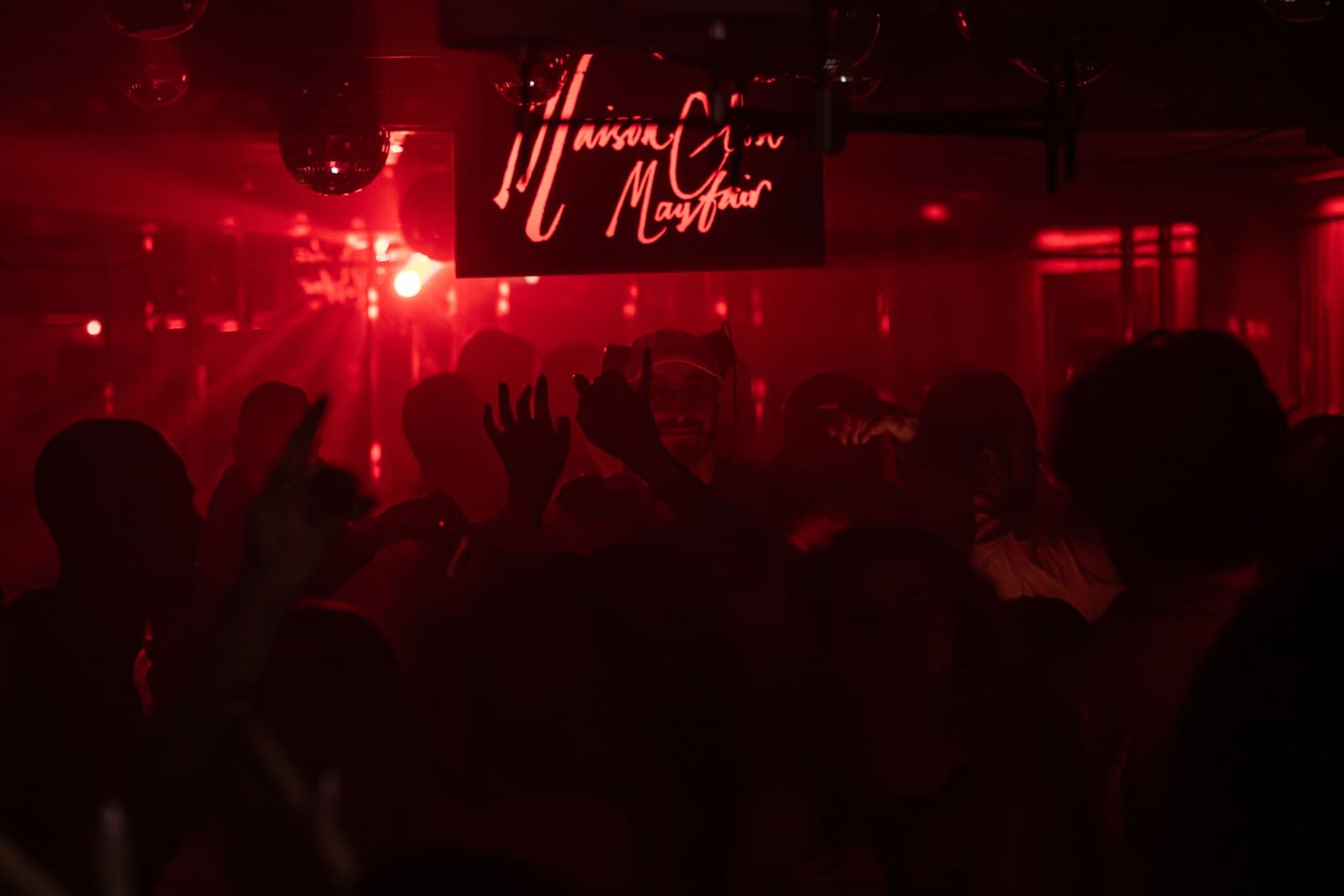 Plush London nightclub interior in the late hours of a big fight night